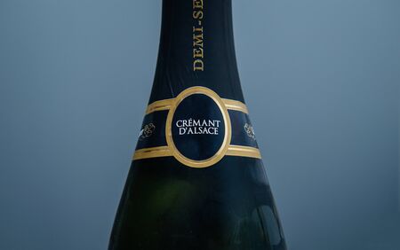 Paris, France - Jan 1, 2020: Close-up detail of Cremant dAlsace sparkling wine against blue backgroundのeditorial素材