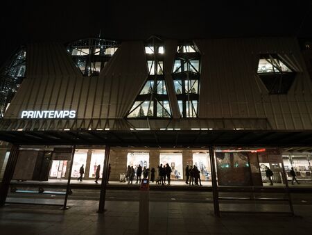 Strasbourg, France - Dec 24, 2018: Place de lHomme de Fer in central Strasbourg with low wide angle of Printemps shopping mall center and pedestrians waiting for the tramway at the stationaのeditorial素材