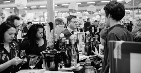Strasbourg, France - Feb 16, 2020: Black and white image of customers tasting French wine at the Vignerons independant English: Independent winemakers of France wine fairのeditorial素材