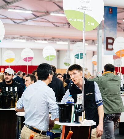 Strasbourg, France - Feb 16, 2020: Side view of men at French wine at the Vignerons independant English: Independent winemakers of France wine fair for private and horeca customersのeditorial素材
