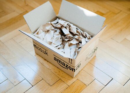 Paris, France - Mar 5, 2014: Overhead view of fresh parcel from Amazon e-commerce shopping site - unboxing unpacking of fresh online ordered goodsのeditorial素材