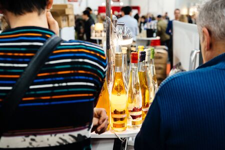 Strasbourg, France - Feb 16, 2020: White wine with visitors people tasting at the Vignerons independant English: Independent winemakers of France wine fair for private and horeca customersのeditorial素材
