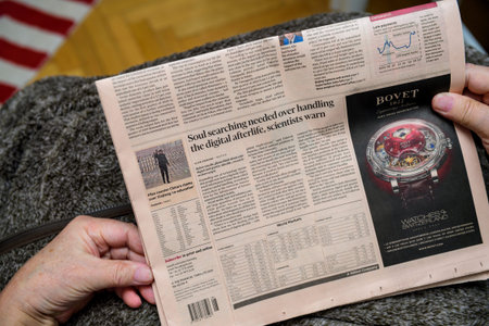Paris, France - Feb 19, 2020: POV of senior hands holding latest Financial Times newspaper featuring...