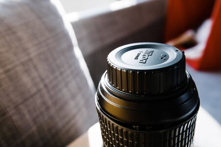 Paris, France - Apr 17, 2019: View of NIkon Logotype on the plastic protection cap over damaged professional 249-70 lensのeditorial素材