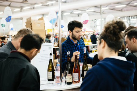 Strasbourg, France - Feb 16, 2020: Adults tasting French wine at the Vignerons independant English:...