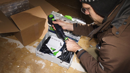 Strasbourg, France - Mar 3, 2020: Overhead view of worker male unboxing parcel containing new best...