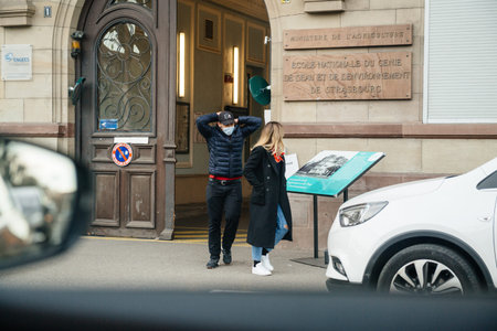 Strasbourg, France - Mar 15, 2020 Young Man wearing protection masc leaving polling station first...