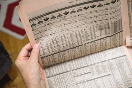 Paris, France - Feb 19, 2020: POV of senior investor hands holding latest Financial Times newspaper...