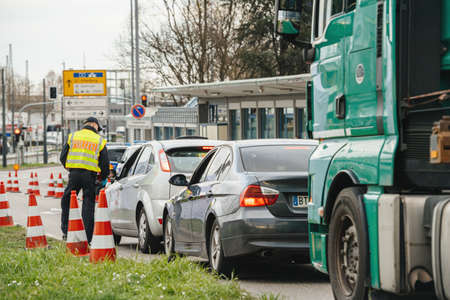 Kehl, Germany - Mar 16, 2020: An officer of the Federal Police checks traffic at the border crossing in Kehl from France Strasbourg during crisis measures in the fight against the novel coronavirus.のeditorial素材