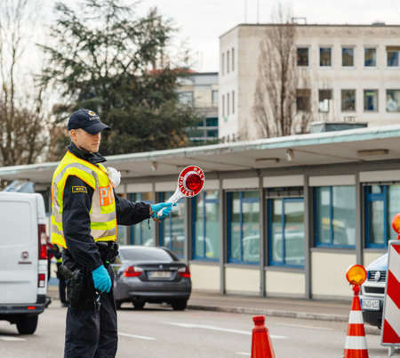 Kehl, Germany - Mar 16, 2020: Square image Federal Police checks traffic at the border crossing in Kehl from France Strasbourg during crisis measures in the fight against the coronavirusのeditorial素材