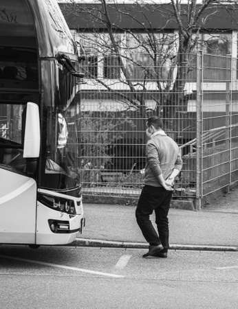 Kehl, Germany - Mar 16, 2020: anxious concerned driver of intercity bus wearing white protection mask checkpoint at border crossing crisis measures against coronavirusのeditorial素材