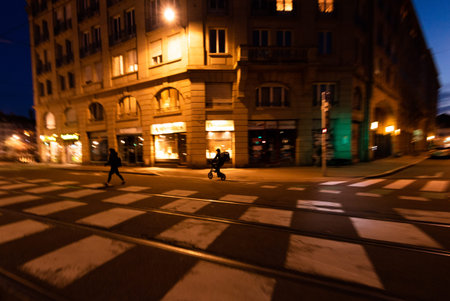 Strasbourg, France - Mar 17, 2020: General view of the empty street and one Deliveroo food delibery...
