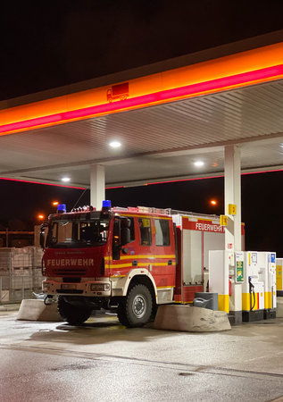 Kehl, Germany - Feb 17, 2020: Feuerwehr Firefighter Iveco Magirus truck loading gas at SHELL gas...