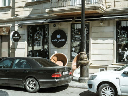 Baku, Azerbaijan - May 2, 2019: Cafe Giusto in central Baku on 5 Niyazi Street with black Mercedes-Benz E320 limousine parked in frontのeditorial素材