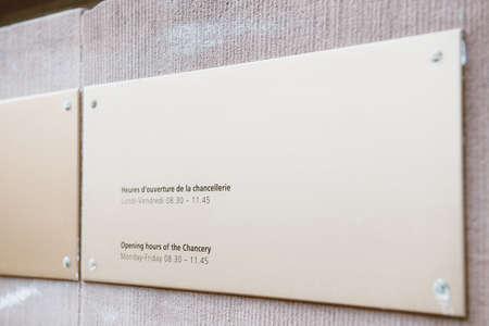 View of generic entrance plaque with opening hours of the Chancellery of Switzerlandのeditorial素材