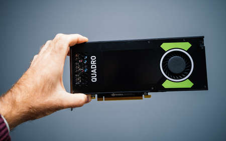 Paris, France - Sep 30, 2019: POV male hand holding new professional Nvidia Quadro P4000 using Pascal microarchitecture front view with logotype blue backgroundのeditorial素材