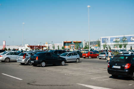 Bucharest, Romania - April 30, 2012: Main parking of large mall supermarket center Baneasa - tilt-shift lens view over cars and customersのeditorial素材