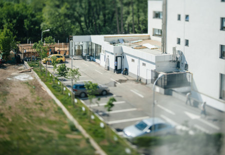 Bucharest, Romania - April 30, 2012: Day scene tilt-shift lens focus view aerial over rear parking...