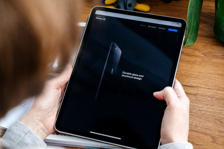 Paris, France - Apr 16, 2020: Durable glass and aluminum design - Woman looking on Apple Computers...