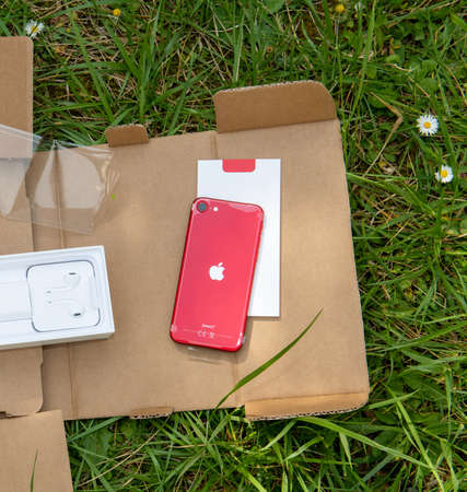 Paris, France - Apr 24, 2020: Parcel with new budget Red iPhone SE by Apple Computers touch ID, Single-lens rear camera and iPhone 8 design with internals from 11 Pro versionのeditorial素材