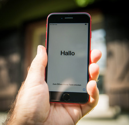 Paris, France - Apr 24, 2020: Hallo translated from German as hello on the new budget iPhone SE by...