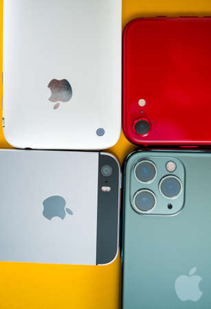Paris, France - Apr 26, 2020: Modern arrangement of smartphones 11 pro, 2016 SE, 3gs next to new budget iPhone SE by Apple Computers touch ID, Single-lens rear camera and iPhone 8 design with internals from 11 Pro versionのeditorial素材