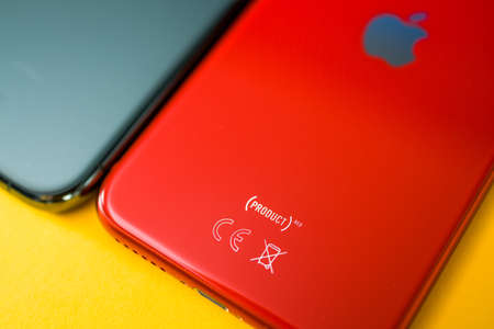 Paris, France - Apr 26, 2020: Product Red logotype on new budget iPhone SE by Apple Computers touch ID, Single-lens rear camera and iPhone 8 design with internals from 11 Pro versionのeditorial素材
