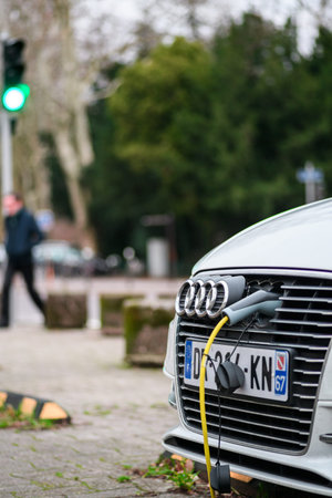 Paris, France - jan 28, 2019: Electric yellow plug in front part of a luxury Audi car parked in the cityのeditorial素材