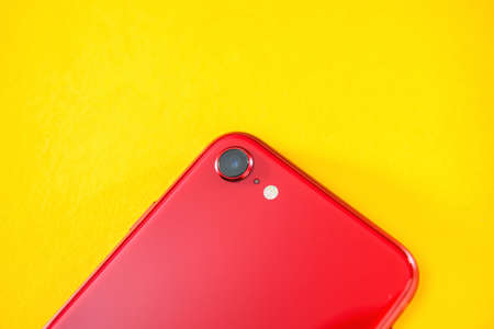Paris, France - Apr 26, 2020: Close-up macro shot of single camera on red new budget iPhone SE by Apple Computers touch ID, Single-lens rear camera and iPhone 8 design with internals from 11 Pro versionのeditorial素材