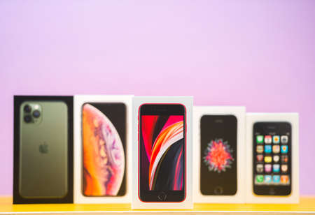Paris, France - Apr 26, 2020: Focus on the latest Se 2020 version with multiple packages cardboards of Apple Computers iphone smartphpone iPhone 3gs, SE 2016, SE 2020, XS and 11 Pro with triple cameras - vintage and new collectionのeditorial素材