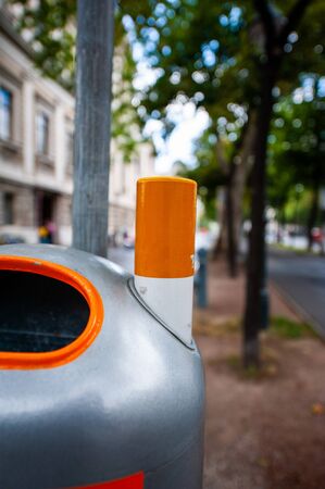 Smokers bin large public furniture ashtray in central Vienna, Austria with defocused city park in the backgroundの写真素材