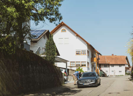 Frankfurt, Germany - Mar 31, 2018: German street near Frankfurt with two seniors talking with driver of a luxury Merceces-Benz carのeditorial素材