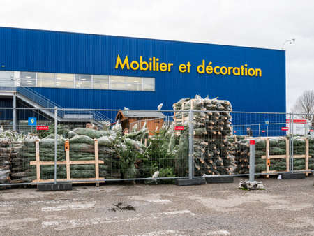 Paris, France - Dec 19, 2017: Security fence around Christmas green fir trees at IKEA supermarket furniture storeのeditorial素材
