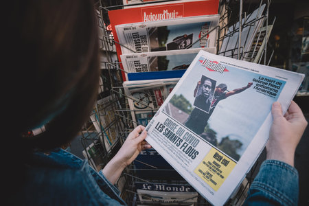 Paris, France - May 30, 2020: POV woman reading at press kiosk Financial Times newspaper featuring US protests following the death of George Floyd by police officer who knelt his neckのeditorial素材