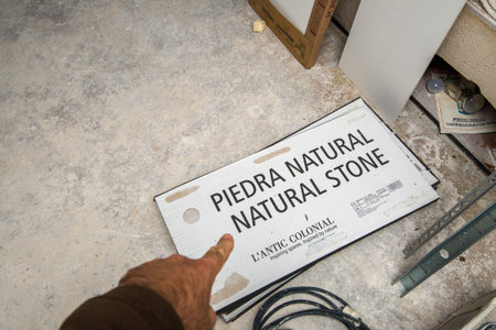 Paris, France - May 29, 2020: Man hand point at the Piedra Natural Natural Stone of L'antic Colonial...