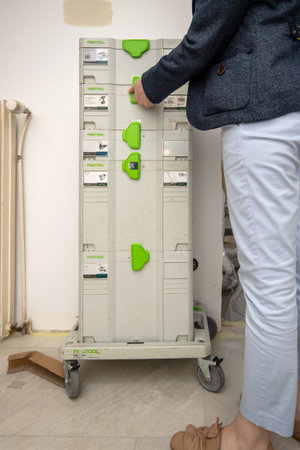 Paris, France - June 8, 2020: Woman near Festool Systainers modular inter-stacking plastic...