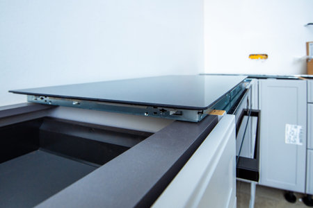Side view of new induction cooktop before installation in a modern luxury kitchenの写真素材