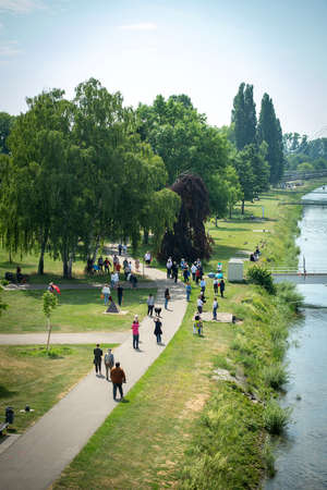 Kehl, Germany - May 9, 2020: Vertical view of demonstrators on Rhine river banks in Kehl waved an umbrella in the name of Franco-German friendship for reopening of borders due to Coronavirus closingのeditorial素材