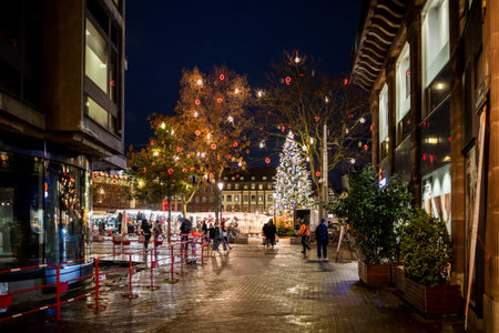 Strasbourg, France - Dec 4, 2020: Strasbourg Central street with few pedestrians during Black Friday and large Christmas tree - lockdown due to COVID-19 pandemicsのeditorial素材