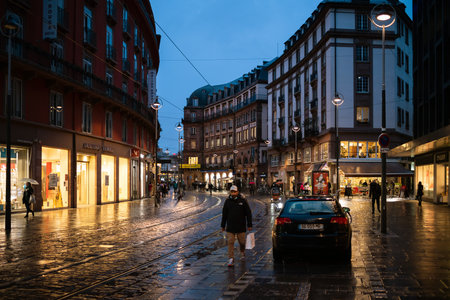 Strasbourg, France - Dec 4, 2020: Man wearing respiratory mask on the almost empty street due to COVID-19 Coronavirus lockdown in French city of Strasbourgのeditorial素材