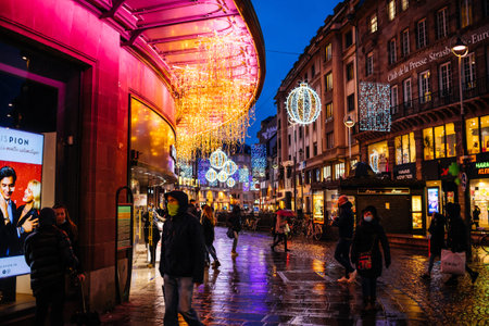 Strasbourg, France - Dec 4, 2020: Few people walking on the empty street of Strasbourg with Christmas decorations during delayed Black Friday due to COVID-19 Coronavirusのeditorial素材