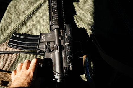 Strasbourg, France - Sep 21, 2019: Man hand on the ready to shoot Heckler and Koch HK416 assault...