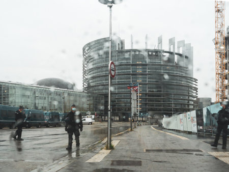 Strasbourg, France - Oct 23, 2020: View rain window of silhouettes of police security forces wearing anti-covid masks Gendarmerie securing the zone around European Parliament during Armenian protestのeditorial素材