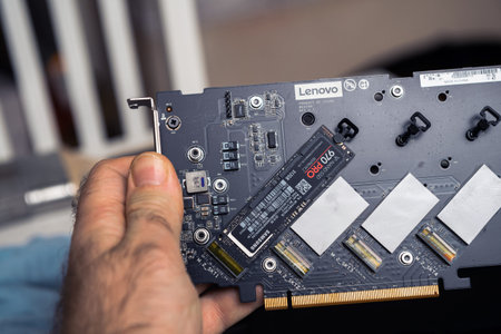 Paris, France - Dec 20, 2020: POV male hand holding Lenovo ThinkStation Quad AIC M.2 SSD Adapter -...