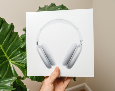 Paris, France - Jan 7, 2020: Male hand shows new package of the best Apple Computers AirPods Max over-ear headphones with Adaptive EQ, Active Noise Cancellation, Transparency mode h1 chips and Siriのeditorial素材
