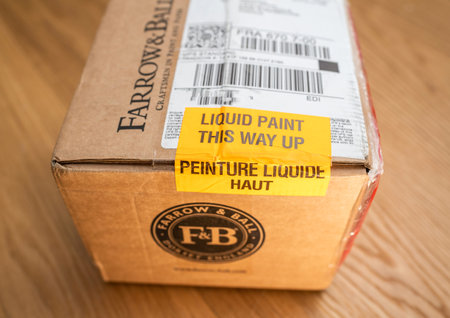 Paris, France - Dec 13, 2020: Liquid Paint THis way up and same text in french language on the parcel from Farrow and Ball luxury British paintのeditorial素材