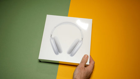 Paris, France - Jan 7, 2020: POV male hand unboxing package of the best Apple Computers AirPods Max...