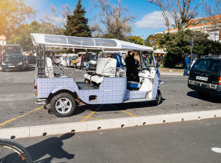 Lisbon, Portugal - Feb 10, 2018: tuk tuk near tourist spot in Lisbon painted in traditional blue colors tiles of portugalのeditorial素材