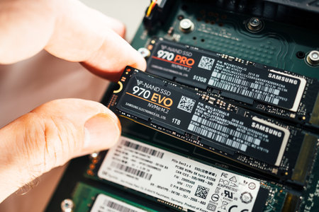 Paris, France - Jan 18, 2019: Male hand arranging inside Dell Ultra Speed Drive Quad NVMe M2 Disk multiple NVME disk from Samsung 970 Pro and 970 Evo and SK Hynix insideのeditorial素材