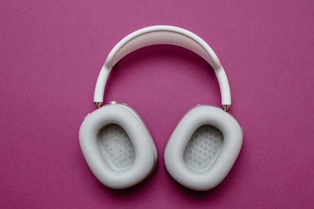 Paris, France - Jan 7, 2020: New Apple Computers AirPods Max over-ear headphones against violet clean backgroundのeditorial素材